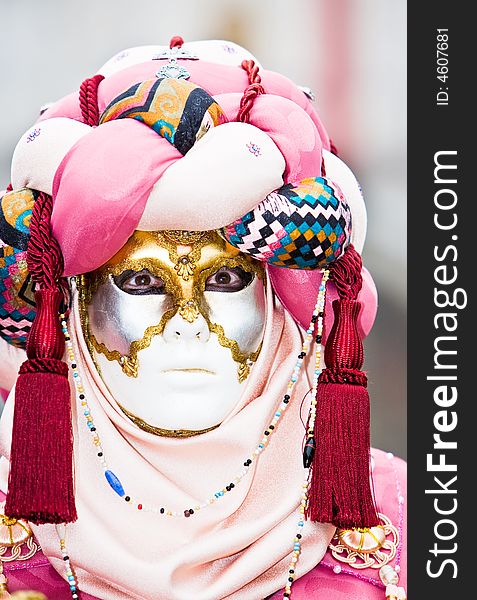 A pink and red mask at the Venice Carnival