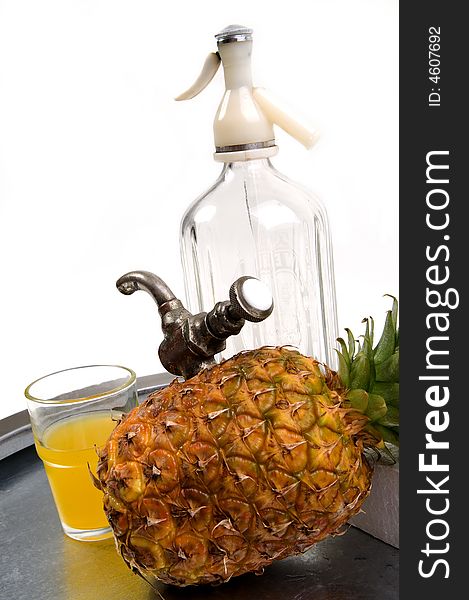 Juicy ananas with tap and soda bottle