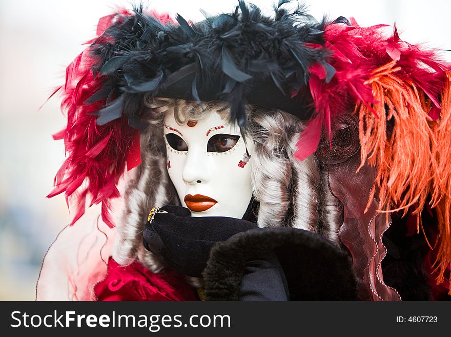 Black and red hat with white mask at the Venice Carnival. Black and red hat with white mask at the Venice Carnival