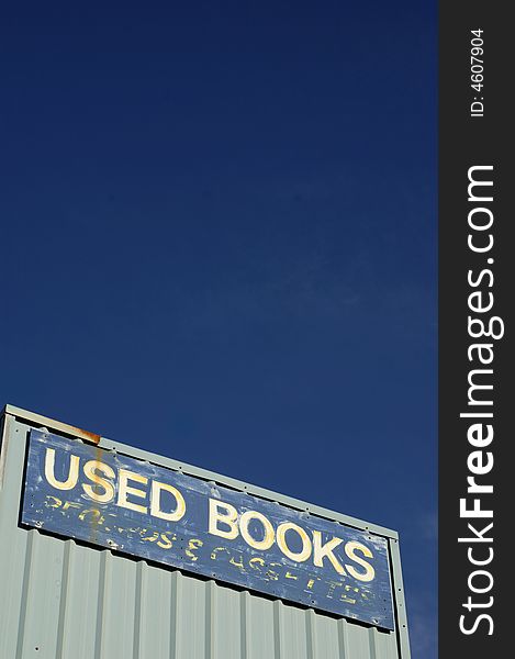 Looking up at exterior of used bookstore sign