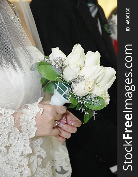 Bride holding white roses wedding flower close up. Bride holding white roses wedding flower close up