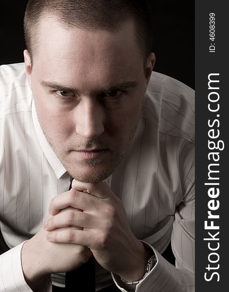 Portrait of a young businessman on black background