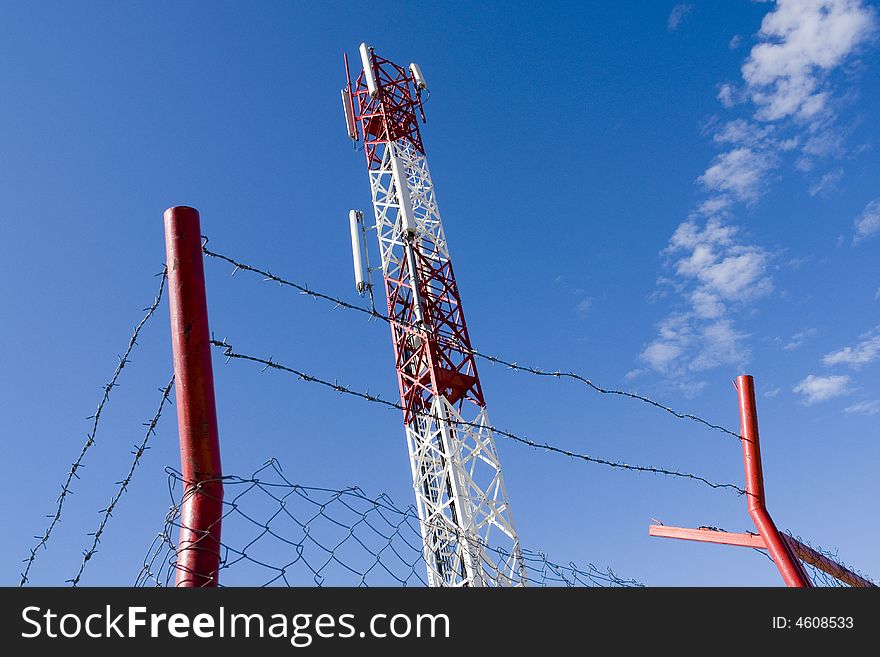 Telecommunication antenna behind the fence