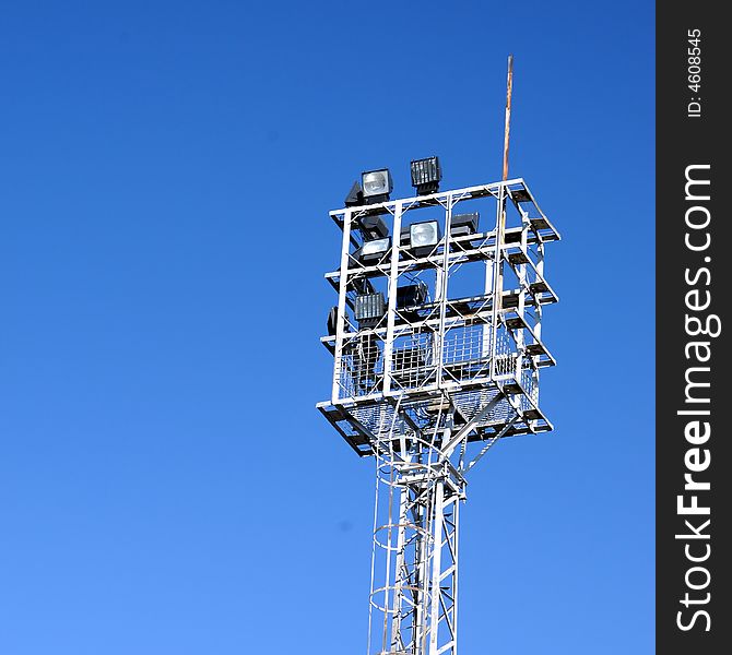 Stadium lights, over a blue sky