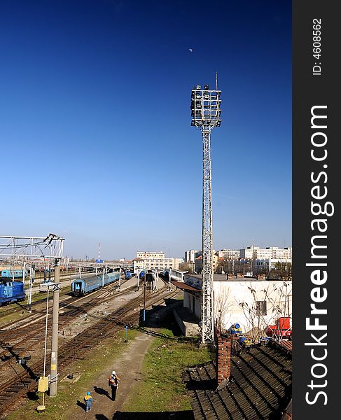 Railway Station in bright sunlight with train departing