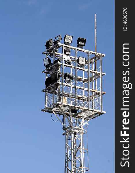 Stadium lights, over a blue sky