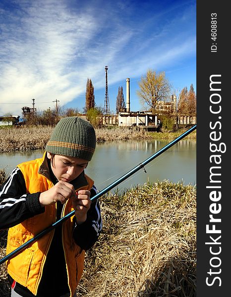 Little boy fishing in an industrial waste waters.