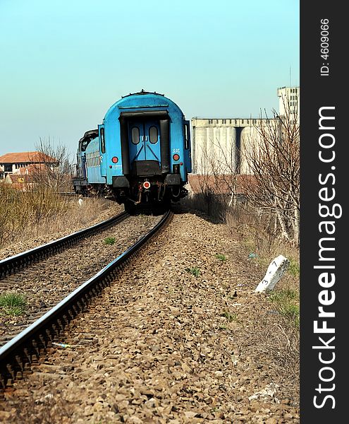 A vertical shot of railroad tracks and train