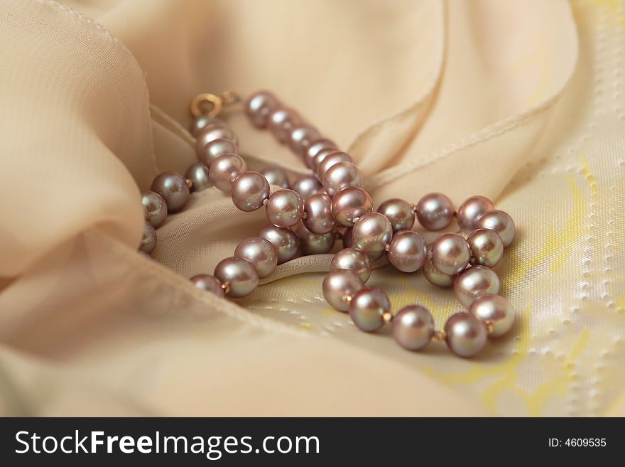 Beautiful pearls on the beige scarf