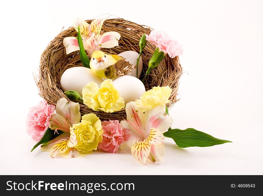 This shot could be for spring or Easter as it has a pretty little bird sitting on three eggs inside a flower strewn birds nest.