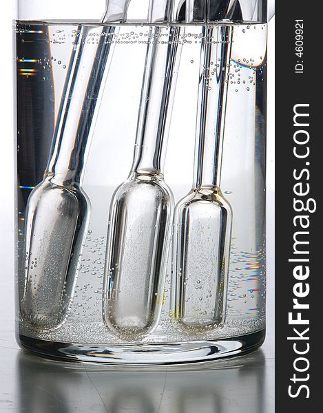 Chemistry tube on glass table, with grey background