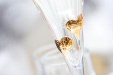 Two Golden Hearts On The Glass Of Champagne Royalty Free Stock Photos