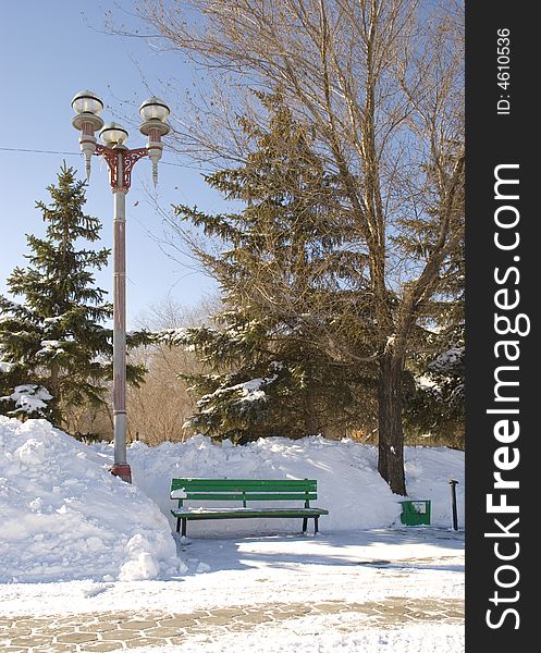 Bench in bright winter day in park. Bench in bright winter day in park