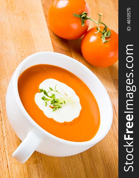 Hot tomato soup with cream and cress