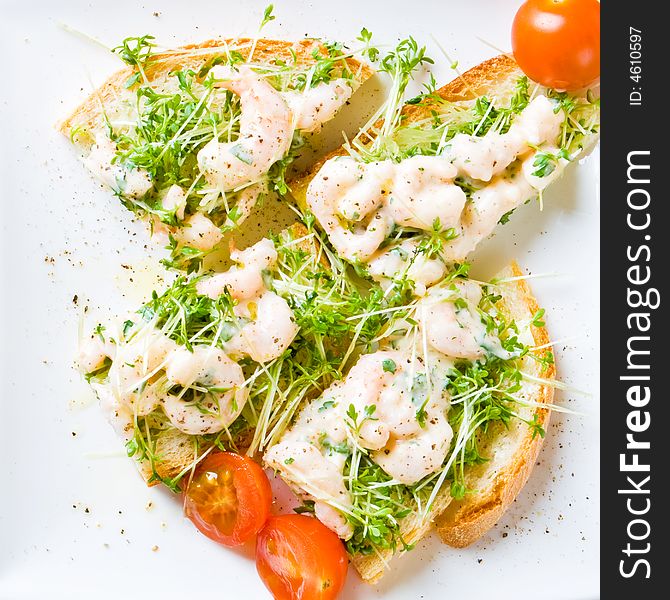 Sliced prawn and cress sandwich with tomato