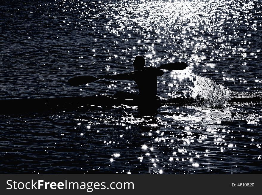 Kayaker's silhouette in sunny backlight. Kayaker's silhouette in sunny backlight