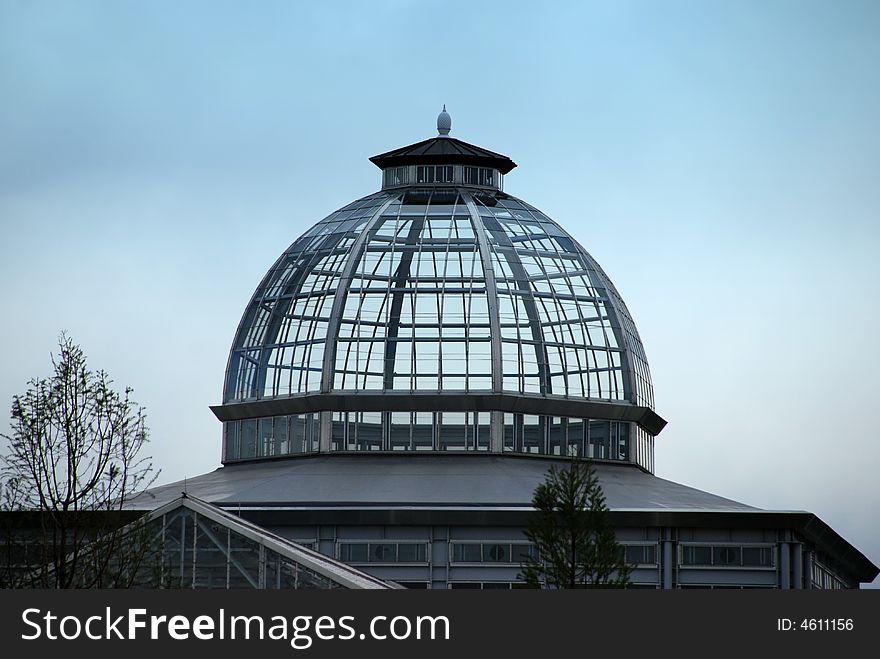 A glass topped building against blue sky. A glass topped building against blue sky