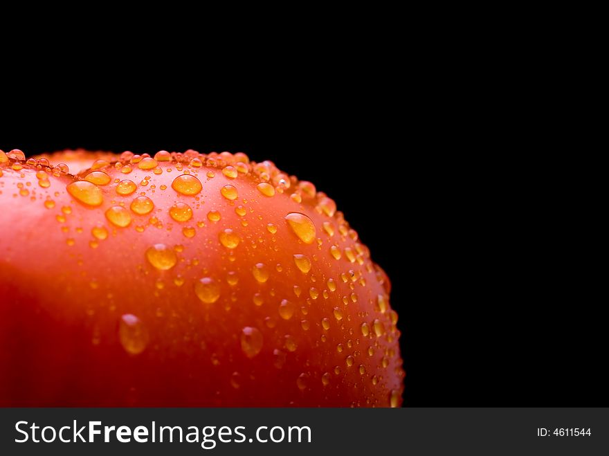 Macro of a fresh red tomato on a black background
