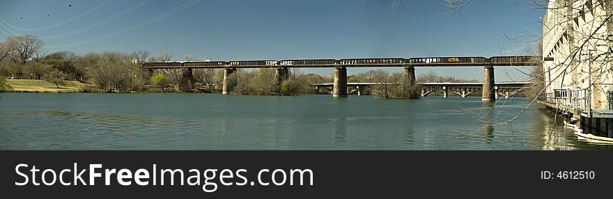 A long railroad bridge with graffiti covering it's sides. A long railroad bridge with graffiti covering it's sides.