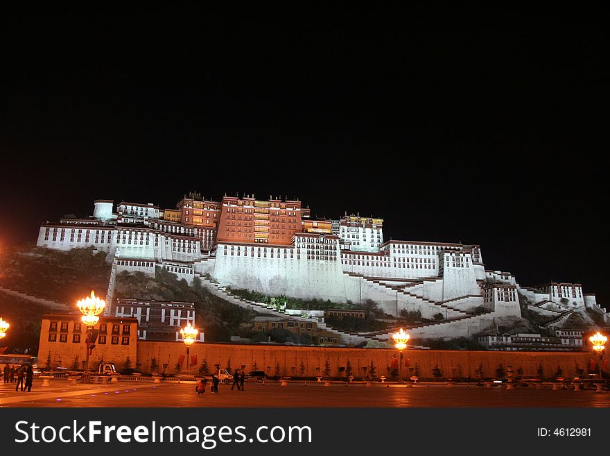 The Potala Palace illuminated at night in Lhasa, Tibet, China. A view at the square in the front. The Potala Palace illuminated at night in Lhasa, Tibet, China. A view at the square in the front.