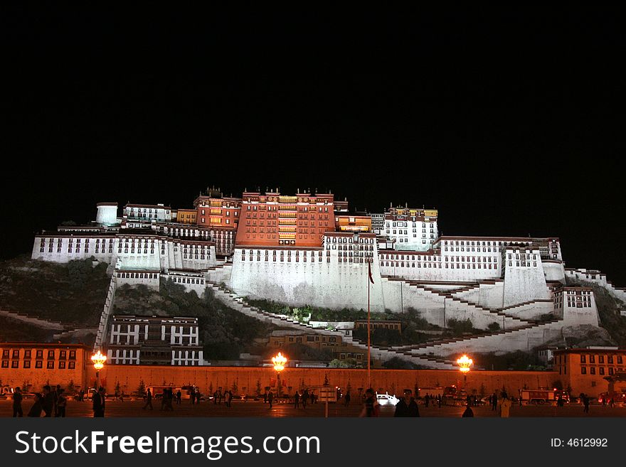 The Potala Palace illuminated at night in Lhasa, Tibet, China. A view at the square in the front. The Potala Palace illuminated at night in Lhasa, Tibet, China. A view at the square in the front.