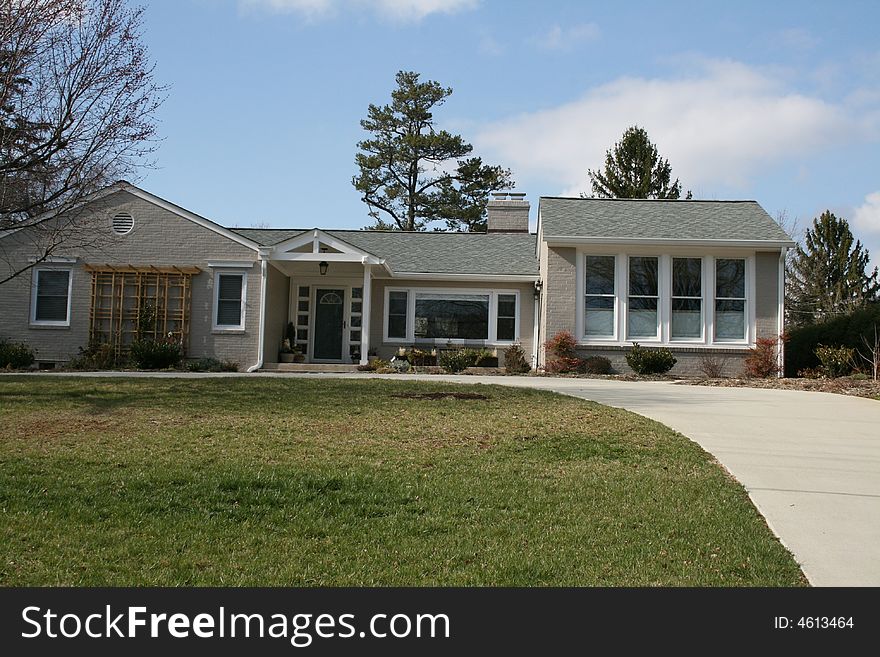 A modern home with concrete drive.