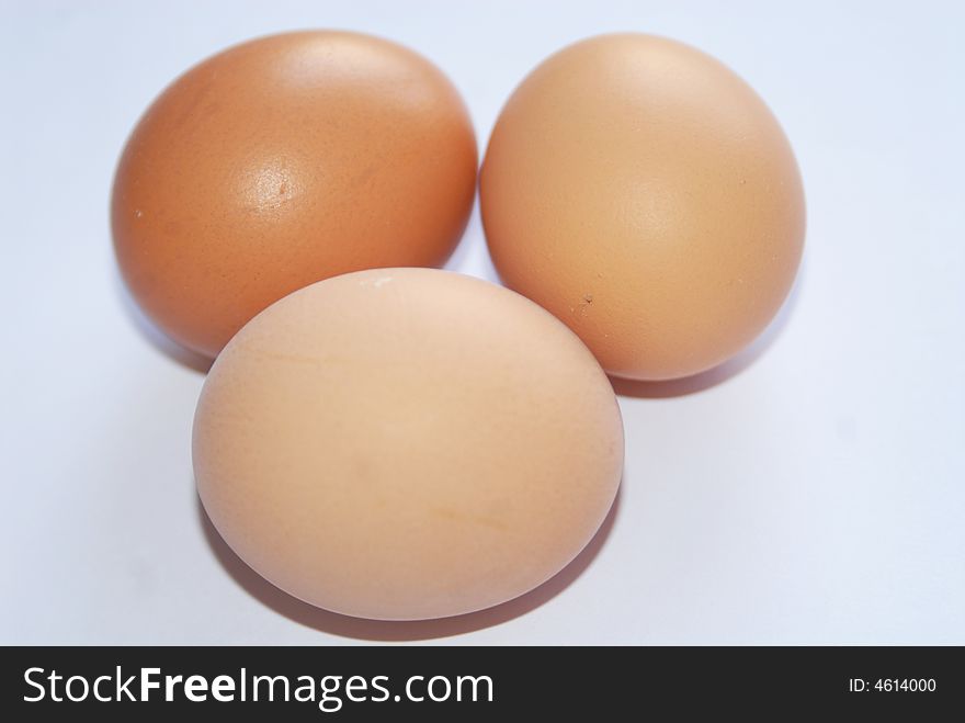 Three fresh eggs on white background