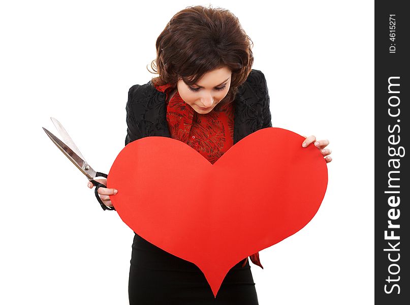 Girl with scissors looking onto a paper heart