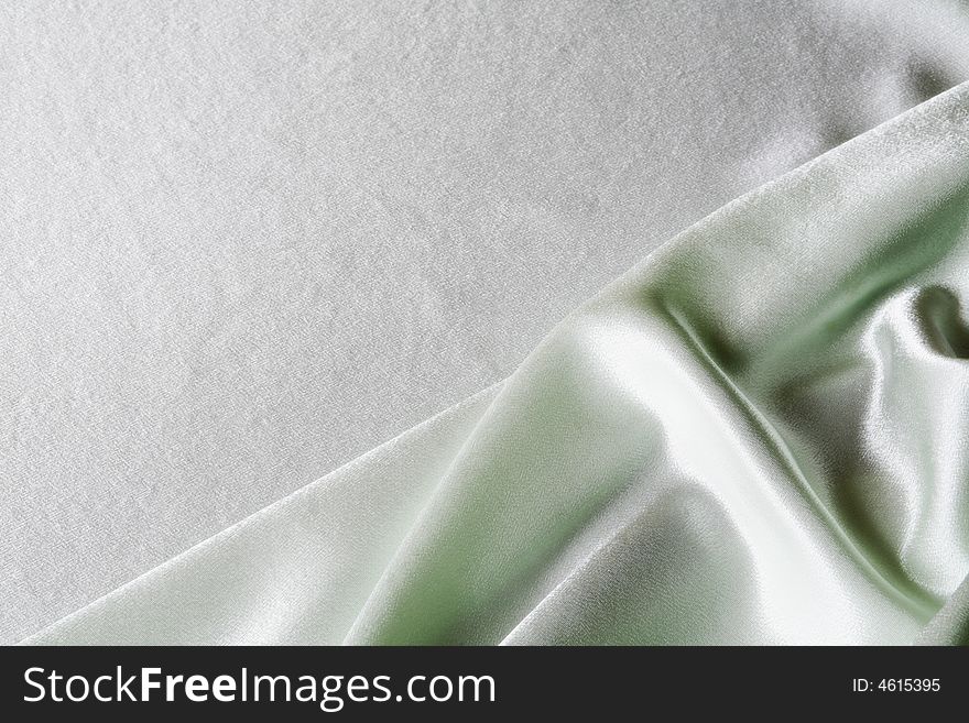 An image of folds of green glace cloth. An image of folds of green glace cloth