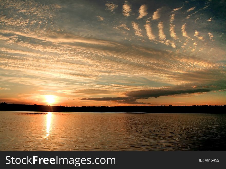 Sunset on the lake with strange clouds