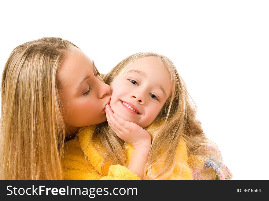 Mother kissing her daughter