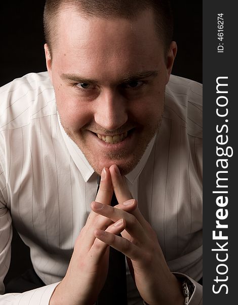 Portrait of a young businessman on black background