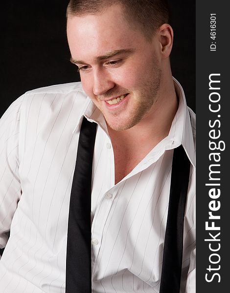 Portrait of a young businessman on black background