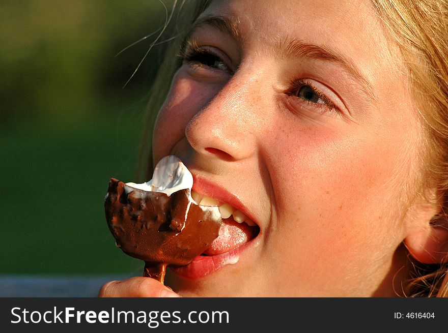 Close-up portrait of girl licking ice-cream. Close-up portrait of girl licking ice-cream