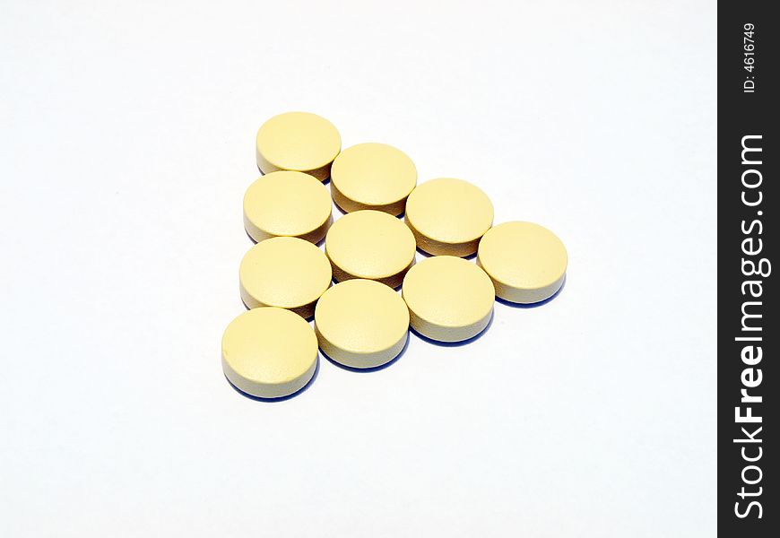 Photo of yellow pills on white background. Photo of yellow pills on white background