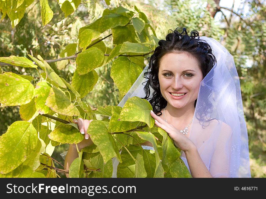 Smiling Bride By The Green Tree