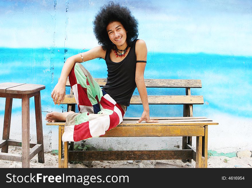 Thai man with a big afro hairstyle isolated on white.