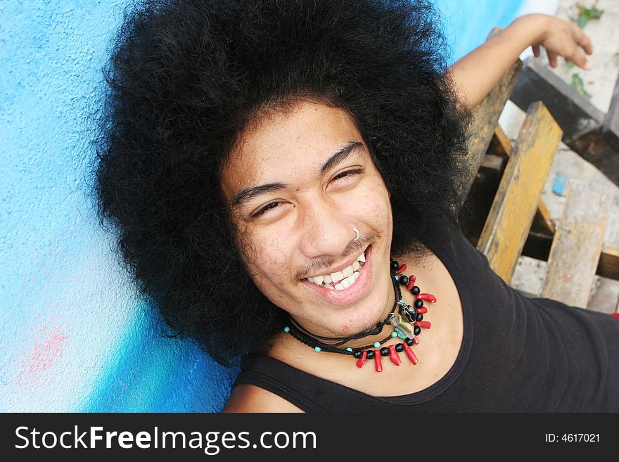 Thai man with a big afro hairstyle isolated on white.