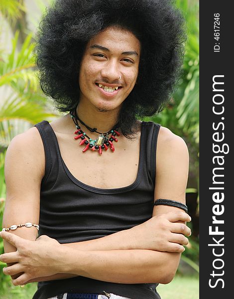 Thai man with a big afro hairstyle isolated on white.