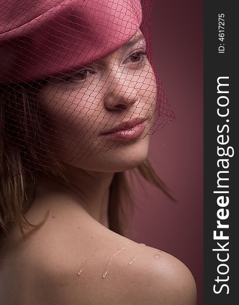 Soft portrait of beautiful elegant model in hat with veil in pink color. Soft portrait of beautiful elegant model in hat with veil in pink color