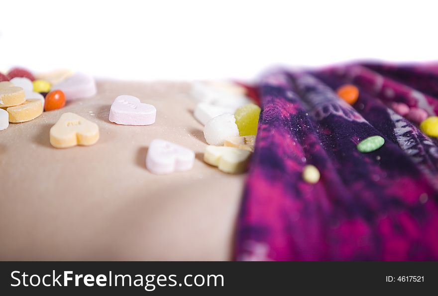 Colorful candies on a girl's body. Colorful candies on a girl's body