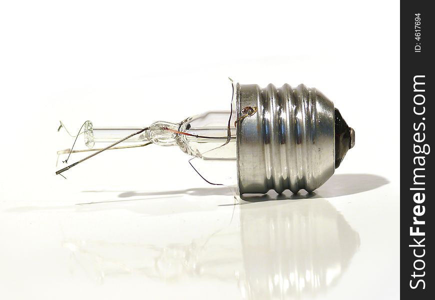 The burned-out light bulb on a white background. The burned-out light bulb on a white background.