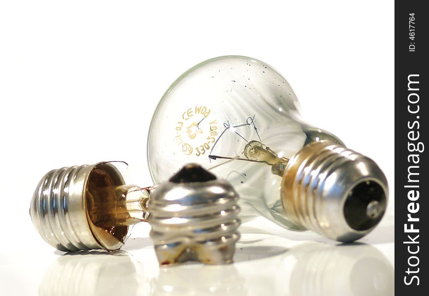 The burned-out light bulb on a white background. The burned-out light bulb on a white background.