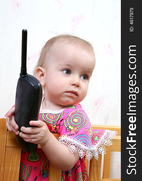 Lovely baby girl in pink dress with phone. Lovely baby girl in pink dress with phone