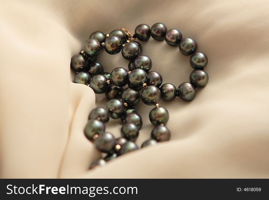 Beautiful pearls on the beige scarf