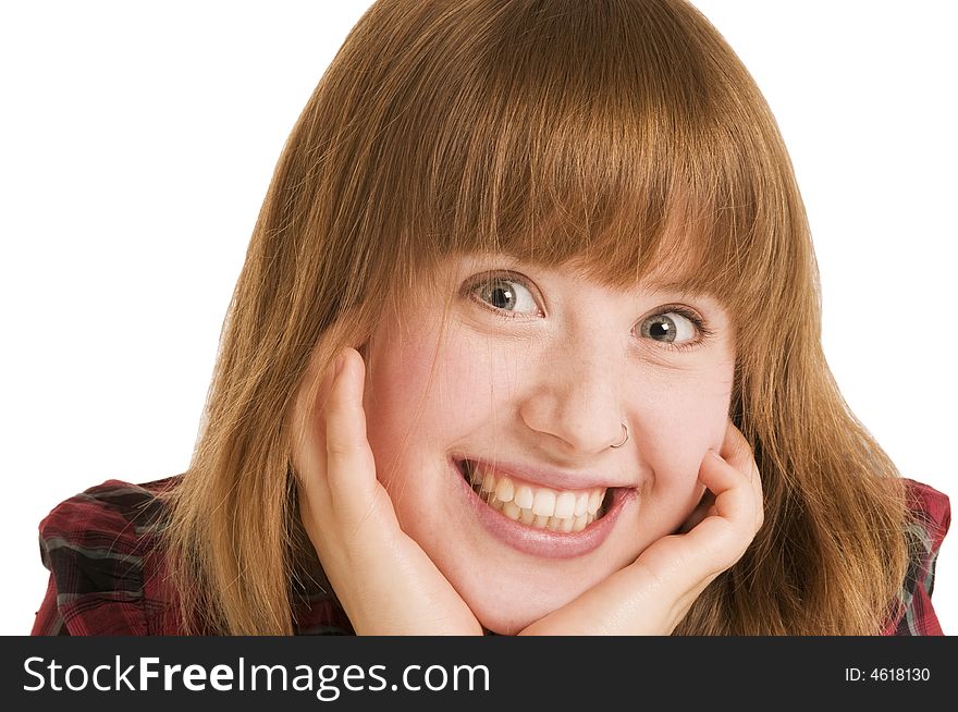 Close-up of a young woman with open smile and hands at the cheeks. Close-up of a young woman with open smile and hands at the cheeks.