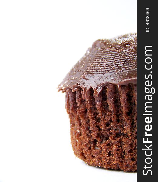 Detailed image of an iced chocolate cupcake, set to the right of the image.  Space remains on left for text or other material.  white background, vertical orientation. Detailed image of an iced chocolate cupcake, set to the right of the image.  Space remains on left for text or other material.  white background, vertical orientation.