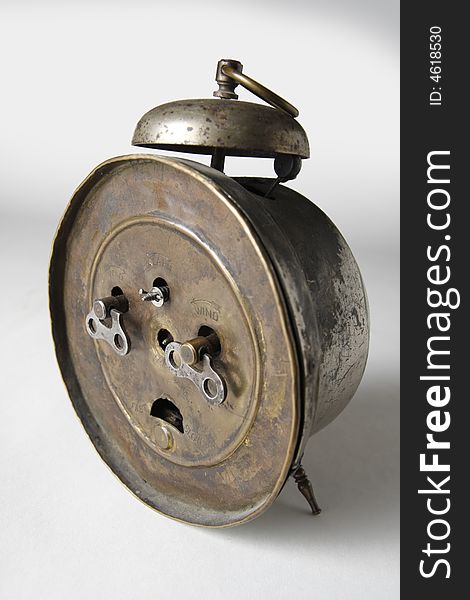 The backside of an old alarm-clock. Clockwork keys. The backside of an old alarm-clock. Clockwork keys.