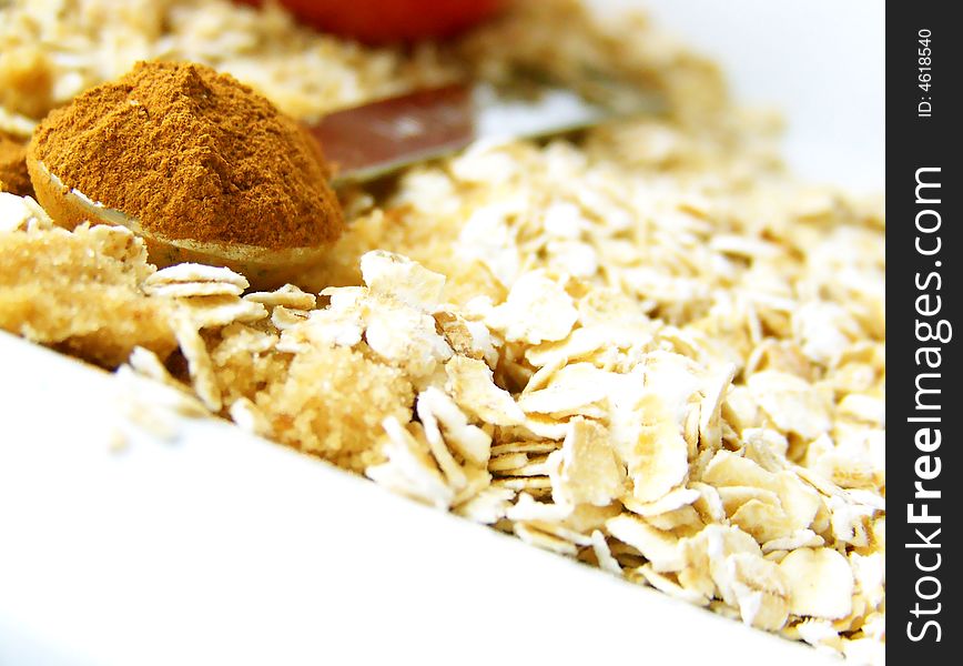 Image of a heaping spoonful of cinnamon, with brown sugar and oats.  Room for text or other material in bottom left of image.  Horizontal orientation. Image of a heaping spoonful of cinnamon, with brown sugar and oats.  Room for text or other material in bottom left of image.  Horizontal orientation.