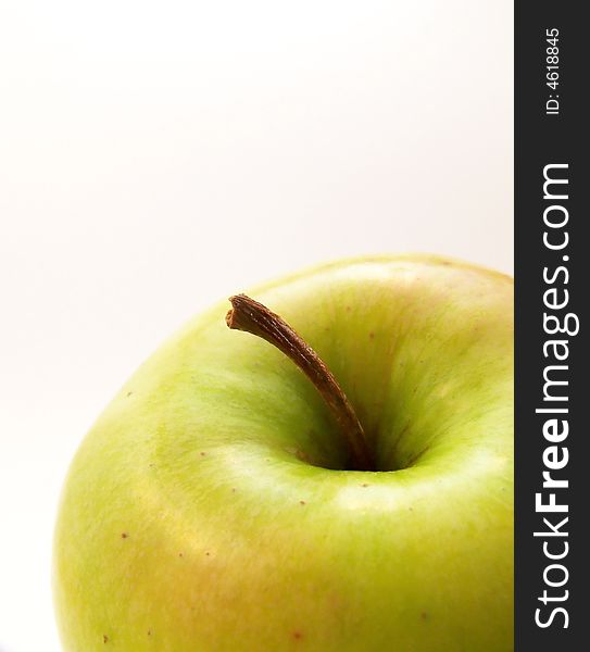 Image of a bright green apple.  White background and vertical orientation.